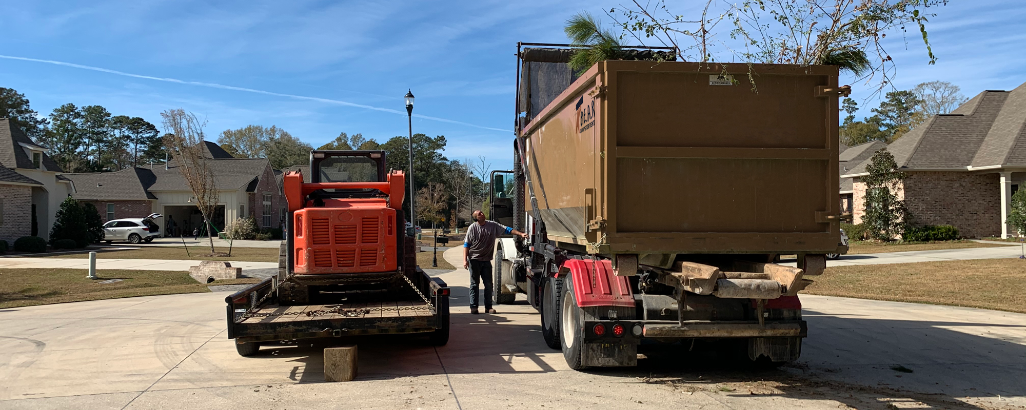 Team At Work Unloading Dumpster